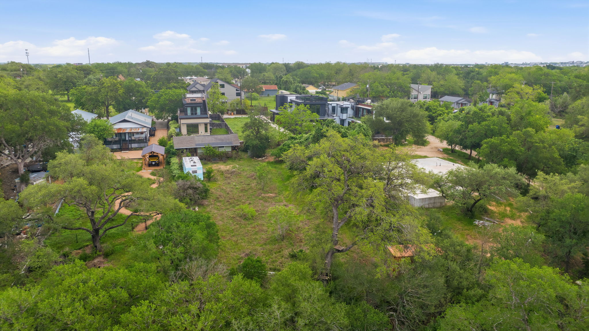 416 Kemp Street Austin, TX 78741 - Photo 11 of 14 This property features extensive natural landscaping with numerous mature trees and substantial green spaces