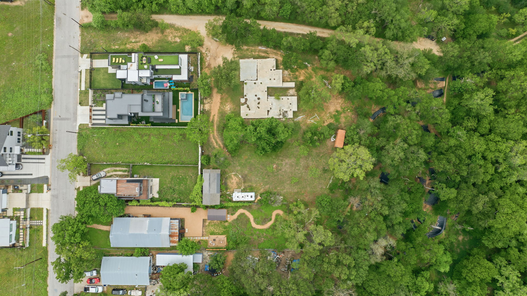 416 Kemp Street Austin, TX 78741 - Photo 12 of 14 Aerial view showcasing a residential area with a paved street, surrounded by extensive green spaces and mature trees