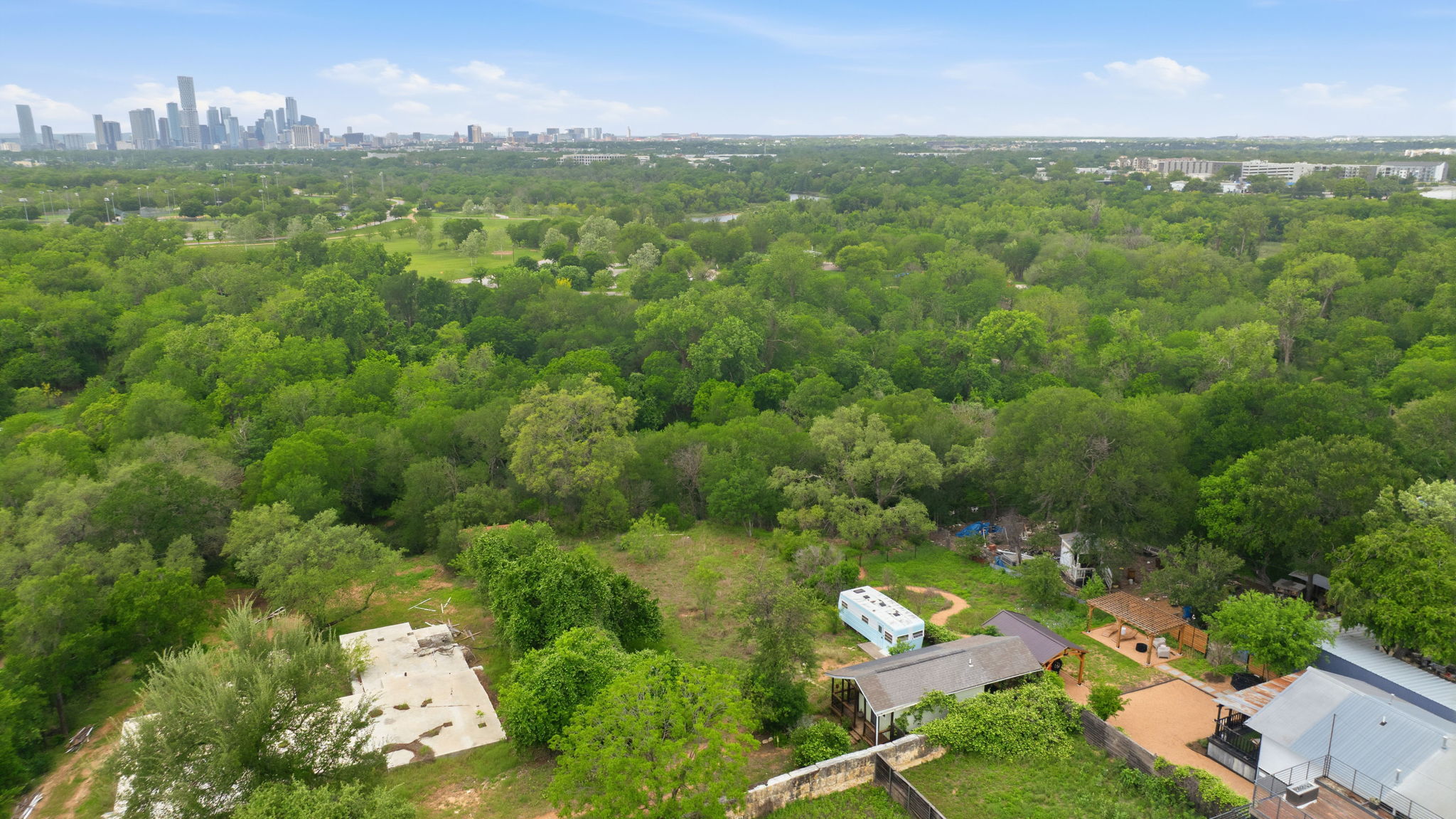 416 Kemp Street Austin, TX 78741 - Photo 9 of 14 This aerial view showcases the property's expansive green surroundings with mature trees