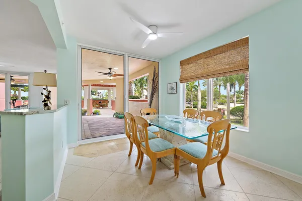 a dining room with furniture a chandelier and wooden floor