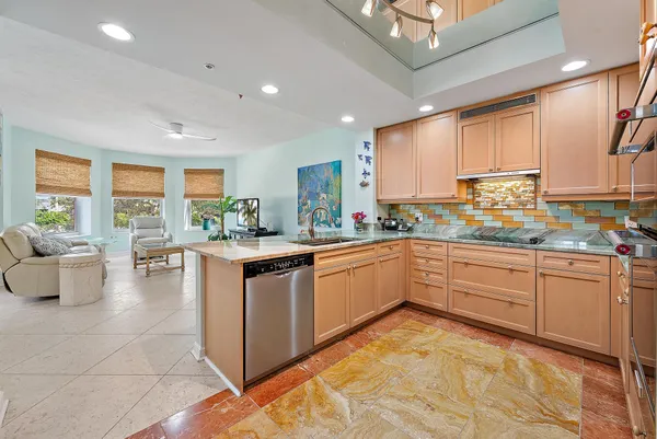 a kitchen with stainless steel appliances granite countertop a sink and cabinets