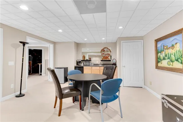 a view of a dining room with furniture and a kitchen