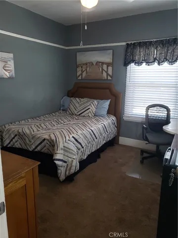a bedroom with a bed and a chair