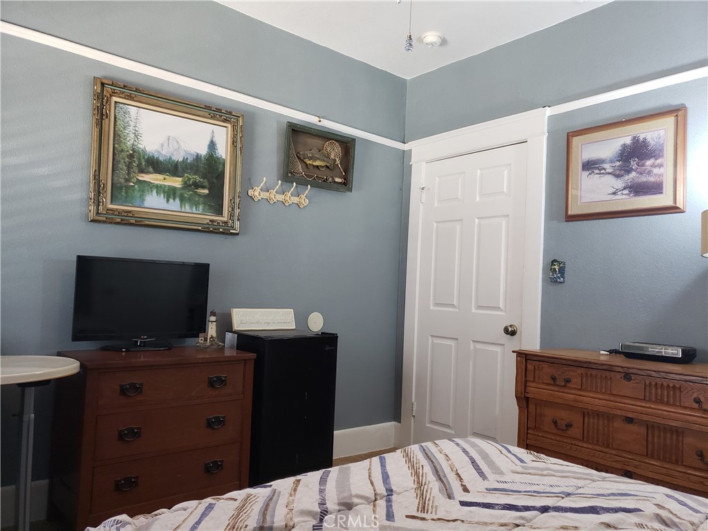 220 West 1st Street San Dimas, CA 91773 - Photo 4 of 5 a bedroom with a bed and a flat screen tv