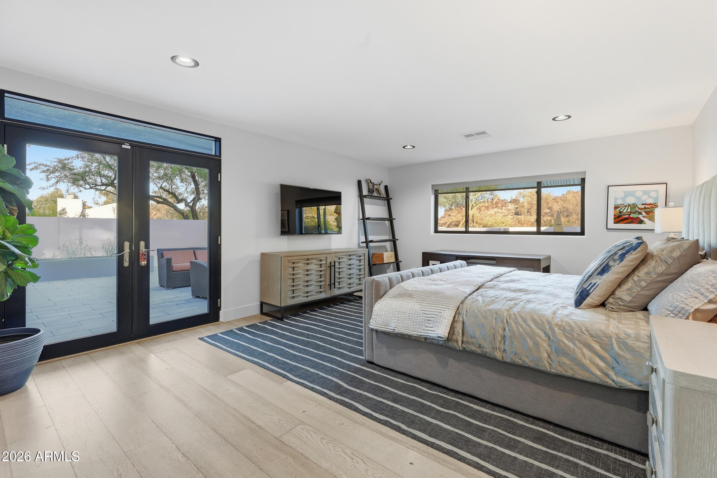 4417 East Mountain View Road Phoenix, AZ 85028 - Photo 21 of 41 a bed room with a bed and a television