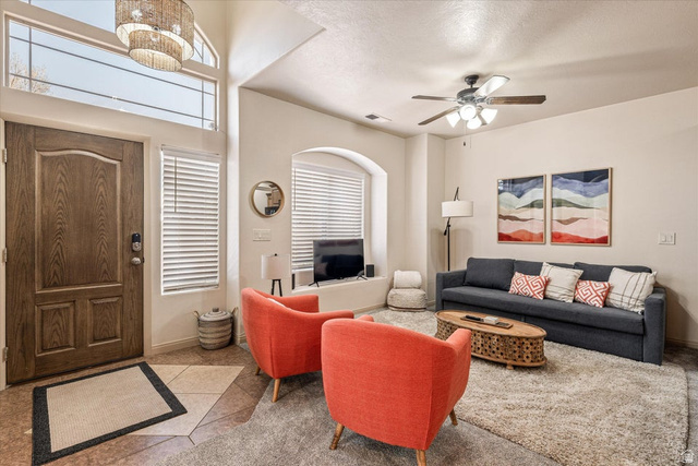 345 North 2450th Street East, Unit 152 St. George, UT 84790 - Photo 8 of 40 Living area with light tile patterned floors, suspended lighting, a ceiling fan, healthy amount of natural light, and a textured ceiling
