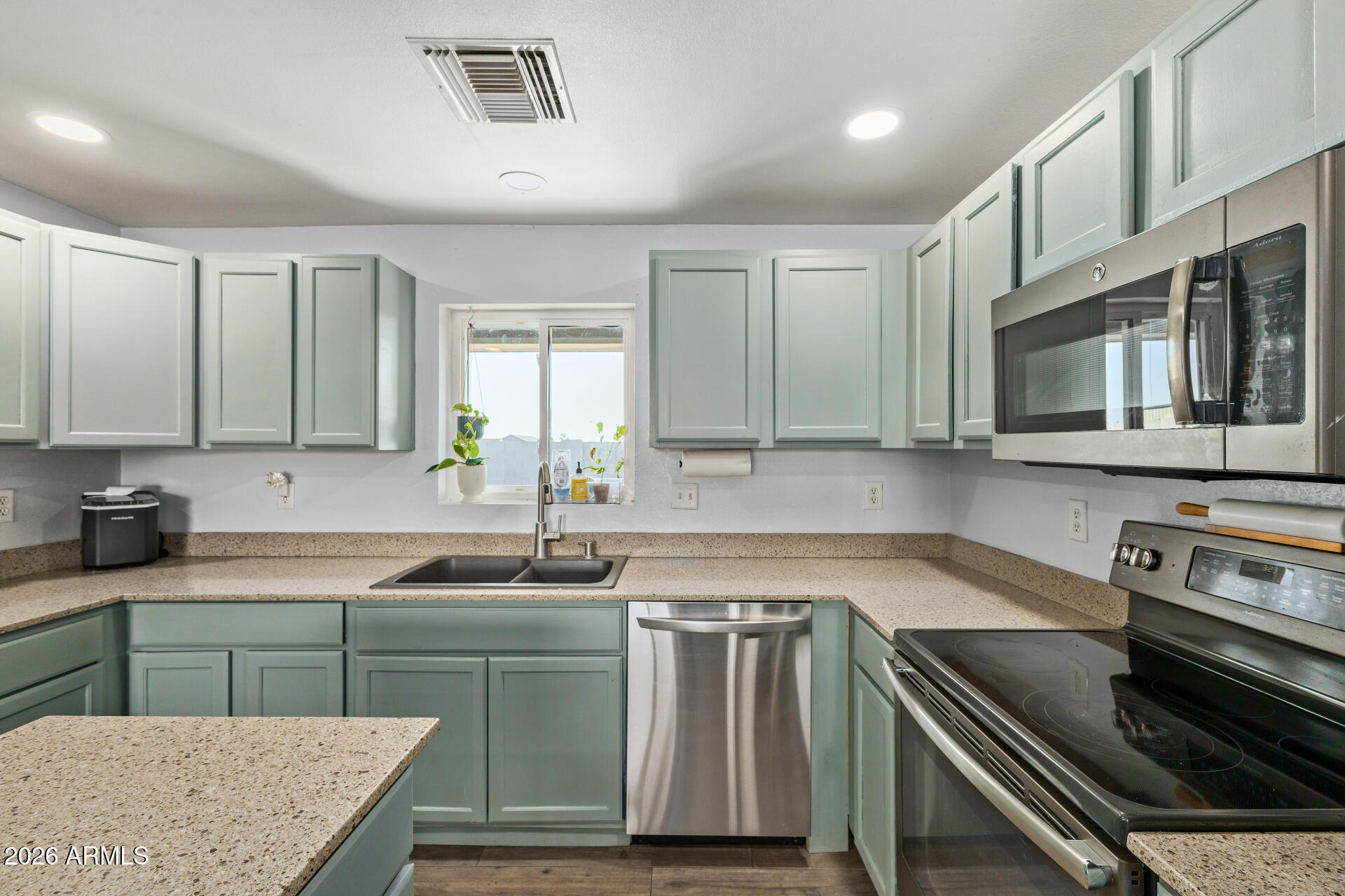 1925 East Greasewood Street Apache Junction, AZ 85119 - Photo 18 of 42 a kitchen with a sink stove top oven and microwave