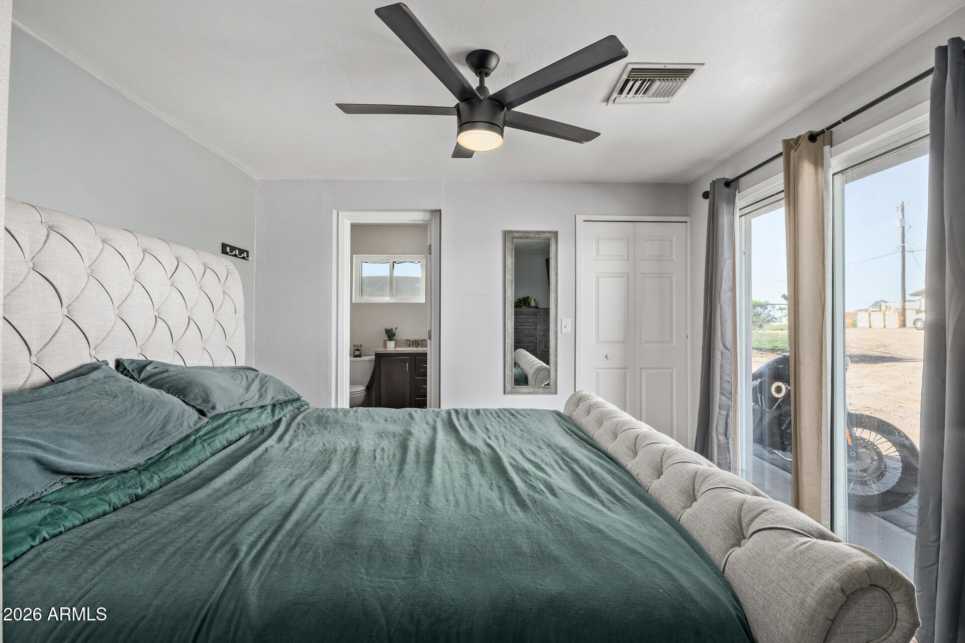 1925 East Greasewood Street Apache Junction, AZ 85119 - Photo 21 of 42 a spacious bedroom with a bed and a chandelier