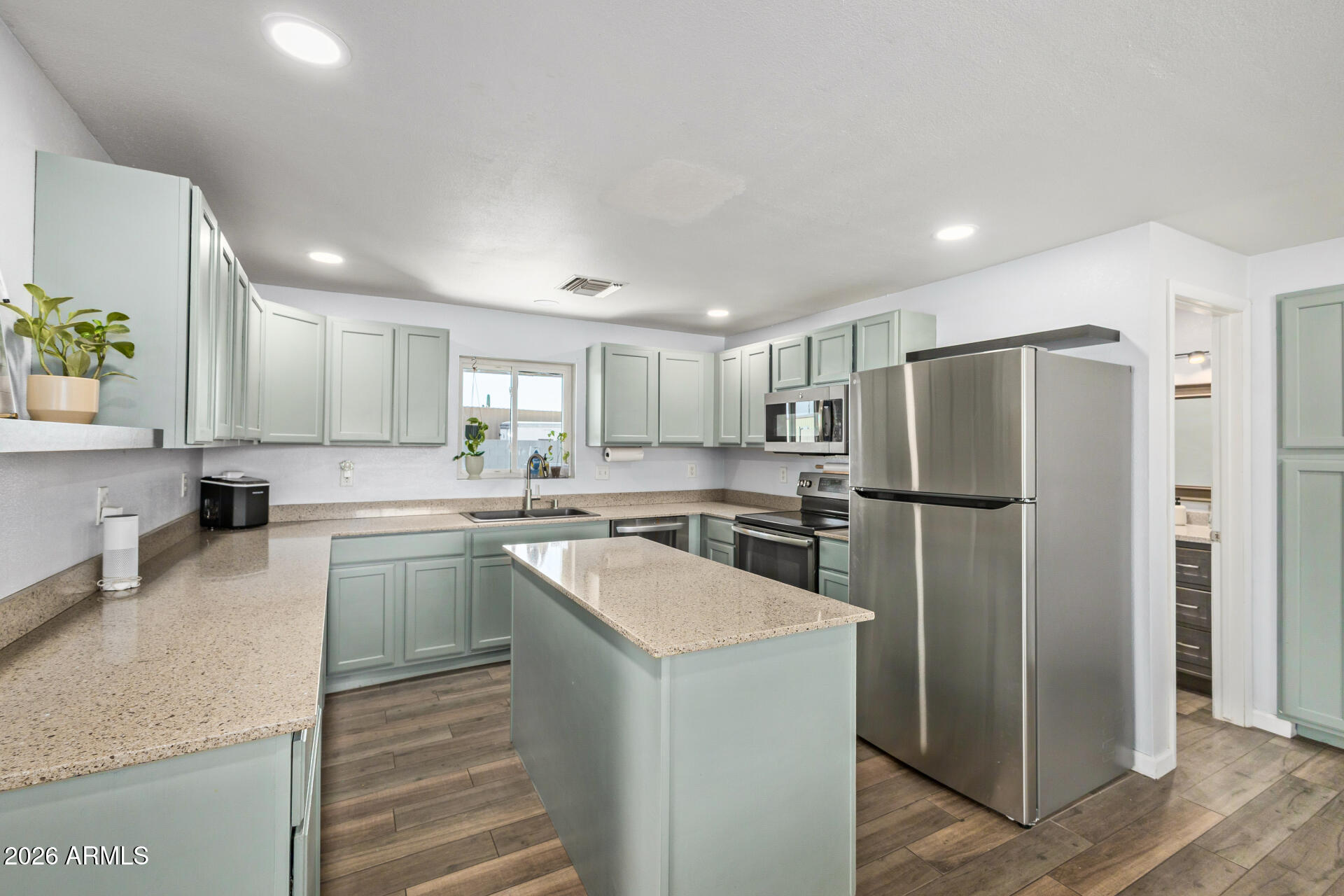1925 East Greasewood Street Apache Junction, AZ 85119 - Photo 3 of 42 a kitchen with a refrigerator a sink and cabinets