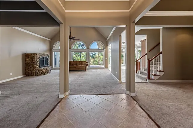 a kitchen with stainless steel appliances granite countertop a refrigerator a stove and a sink with wooden cabinets