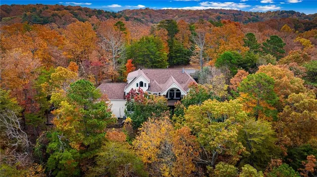 an aerial view of house with yard and mountain view in back