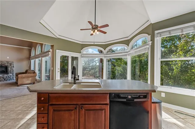 a living room with furniture a rug and a large window