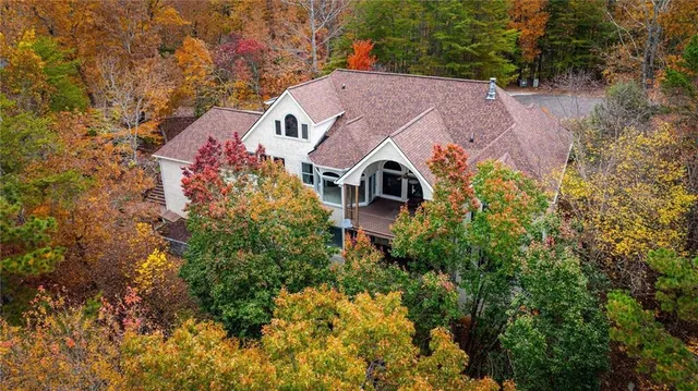a front view of a house with a yard and garden