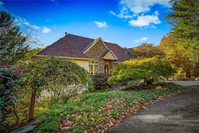 a living room with furniture a ceiling fan and a large window
