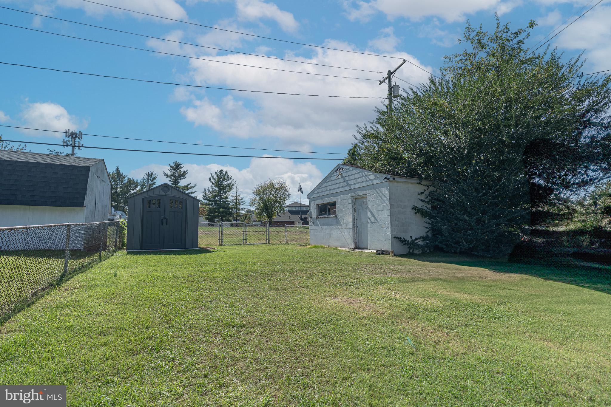 53 Chandelle Road Baltimore, MD 21220 - Photo 11 of 15 a view of a house with a yard and garage