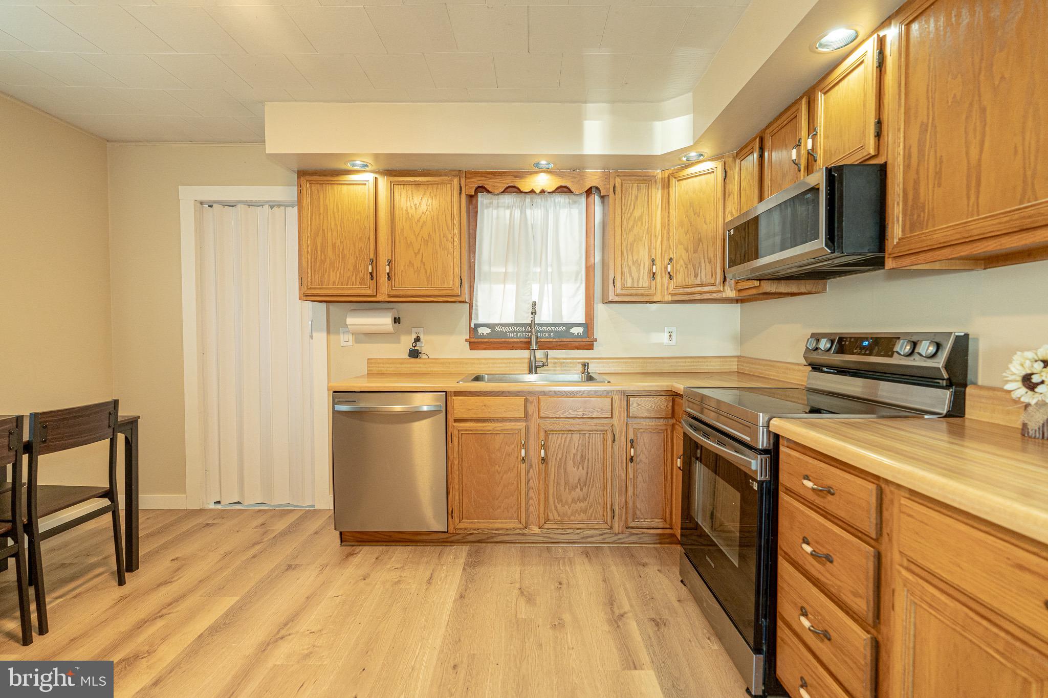 53 Chandelle Road Baltimore, MD 21220 - Photo 5 of 15 a kitchen with a sink stove and cabinets