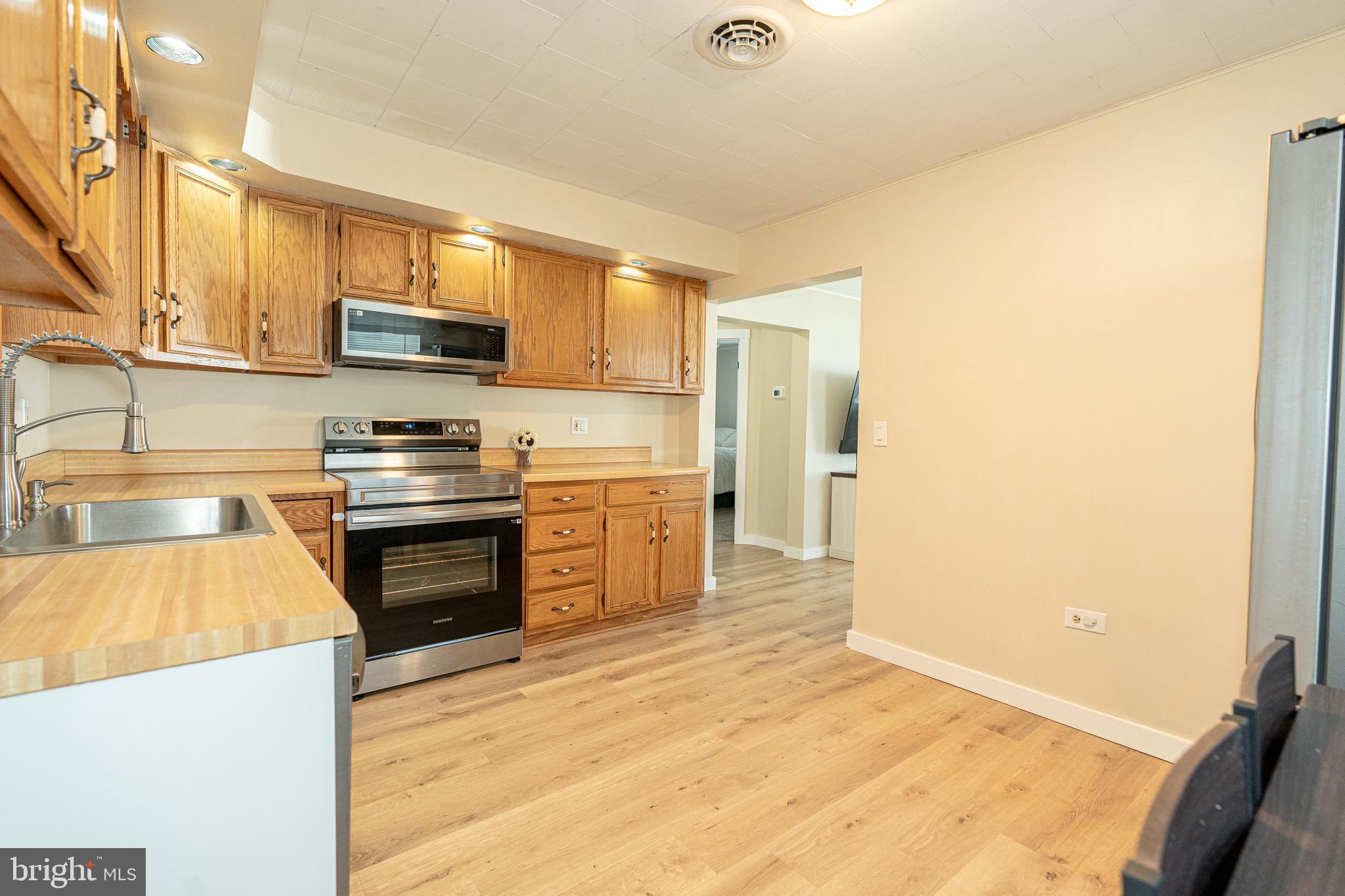 53 Chandelle Road Baltimore, MD 21220 - Photo 6 of 15 a kitchen with stainless steel appliances a refrigerator and a stove top oven