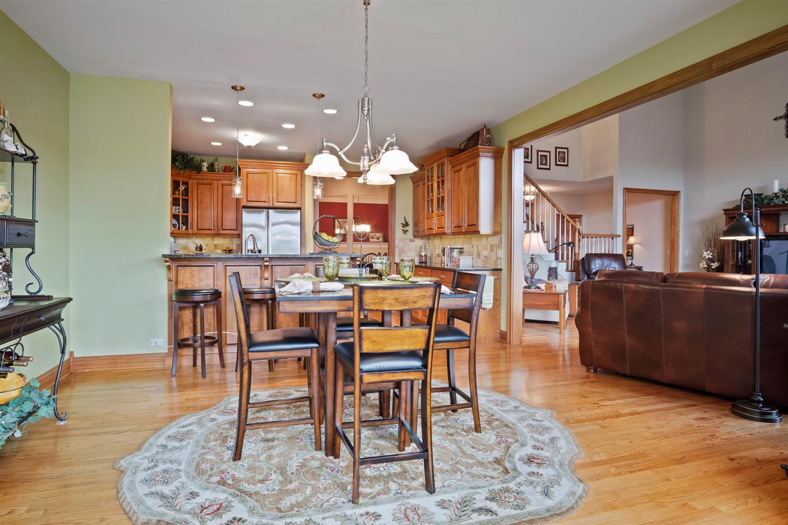 3705 Ridge Pointe Drive Geneva, IL 60134 - Photo 15 of 35 a living room with dining room and wooden floor