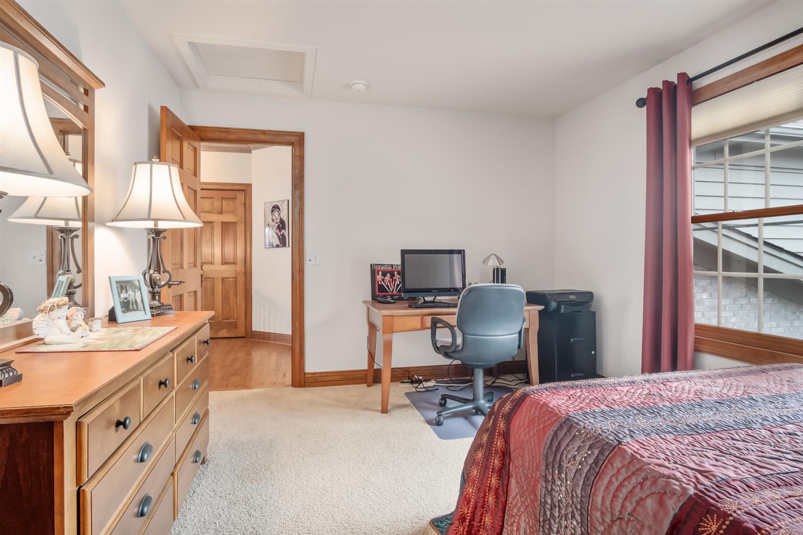 3705 Ridge Pointe Drive Geneva, IL 60134 - Photo 25 of 35 a bedroom with a bed and a chair