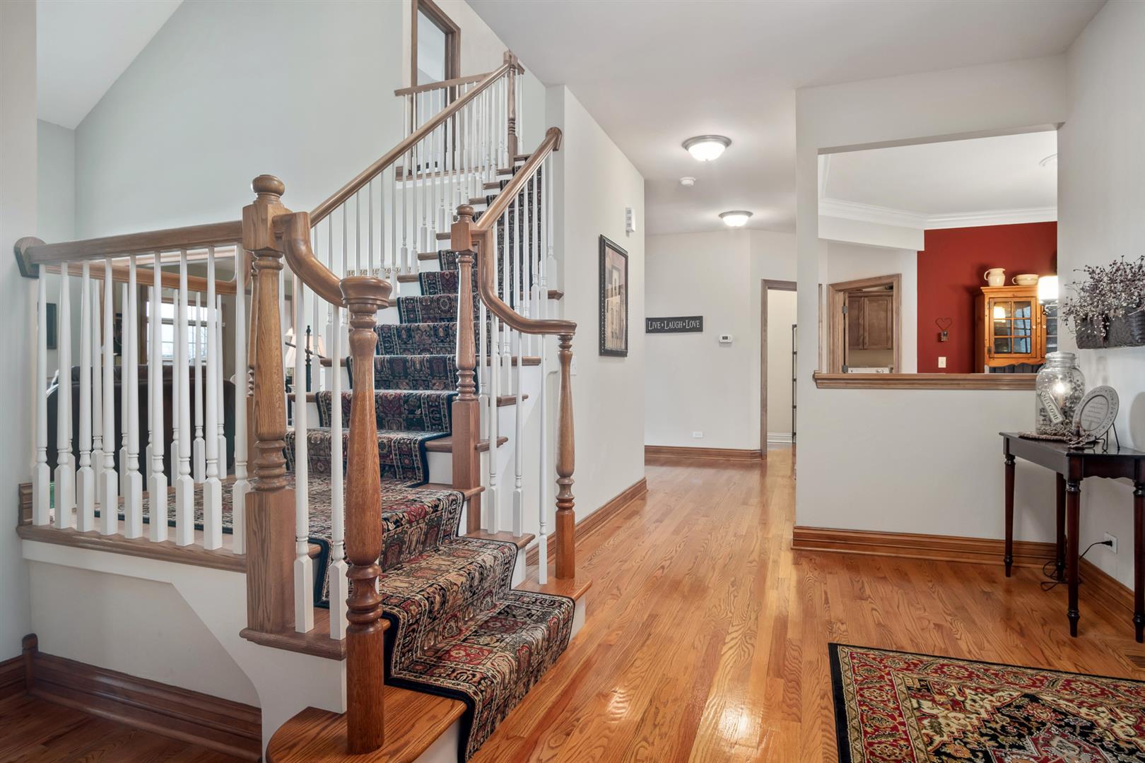 3705 Ridge Pointe Drive Geneva, IL 60134 - Photo 4 of 35 a view of a hallway with wooden floor and staircase