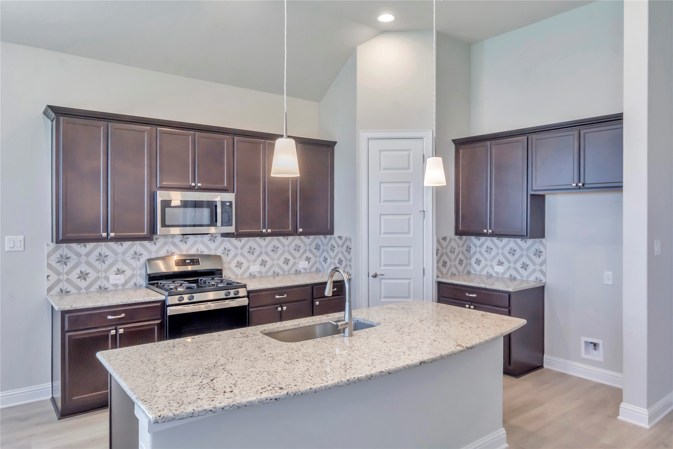 2140 Base Burner Path Leander, TX 78641 - Photo 9 of 27 a kitchen with stainless steel appliances granite countertop a sink stove and refrigerator