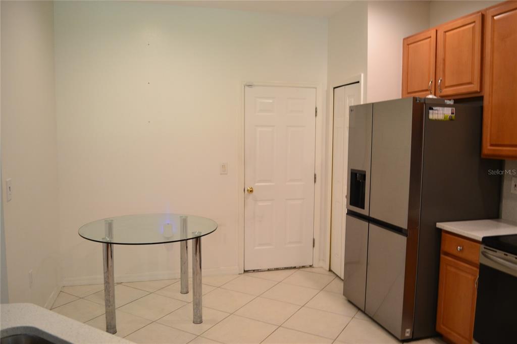11235 Kapok Grand Circle Madeira Beach, FL 33708 - Photo 4 of 34 a kitchen with stainless steel appliances a refrigerator and a cabinets