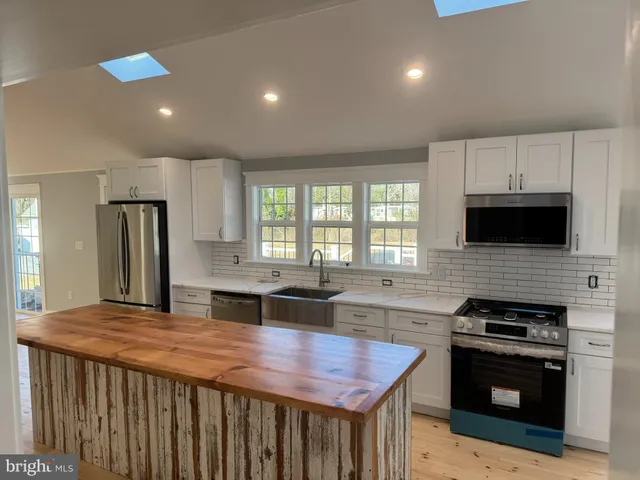 an entryway and livingroom with furniture