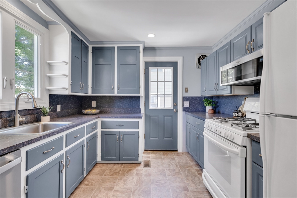 16 Roundwood Road Newton, MA 02464 - Photo 14 of 41 a kitchen with stainless steel appliances granite countertop a stove sink and cabinets