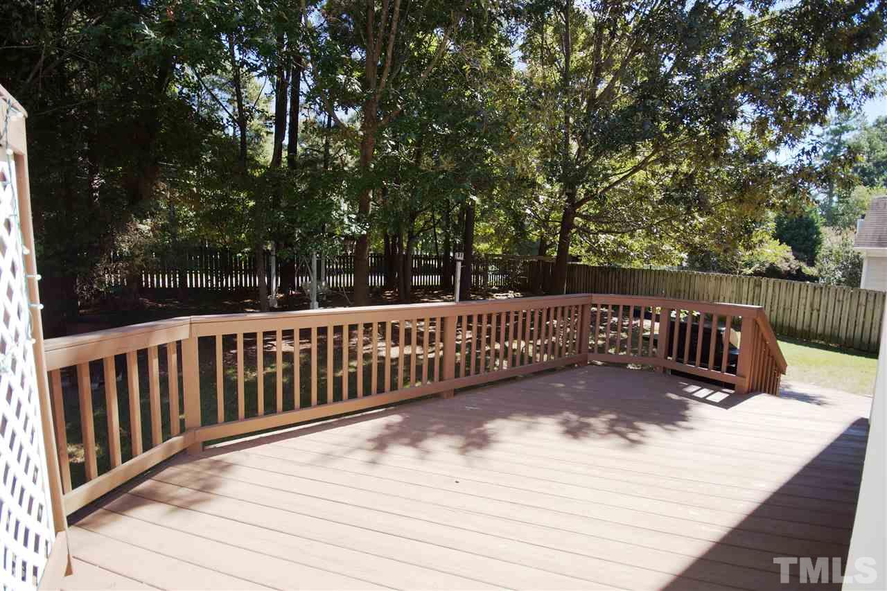 12216 Breton Lane Raleigh, NC 27613 - Photo 22 of 25 a view of deck and deck with trees in the background