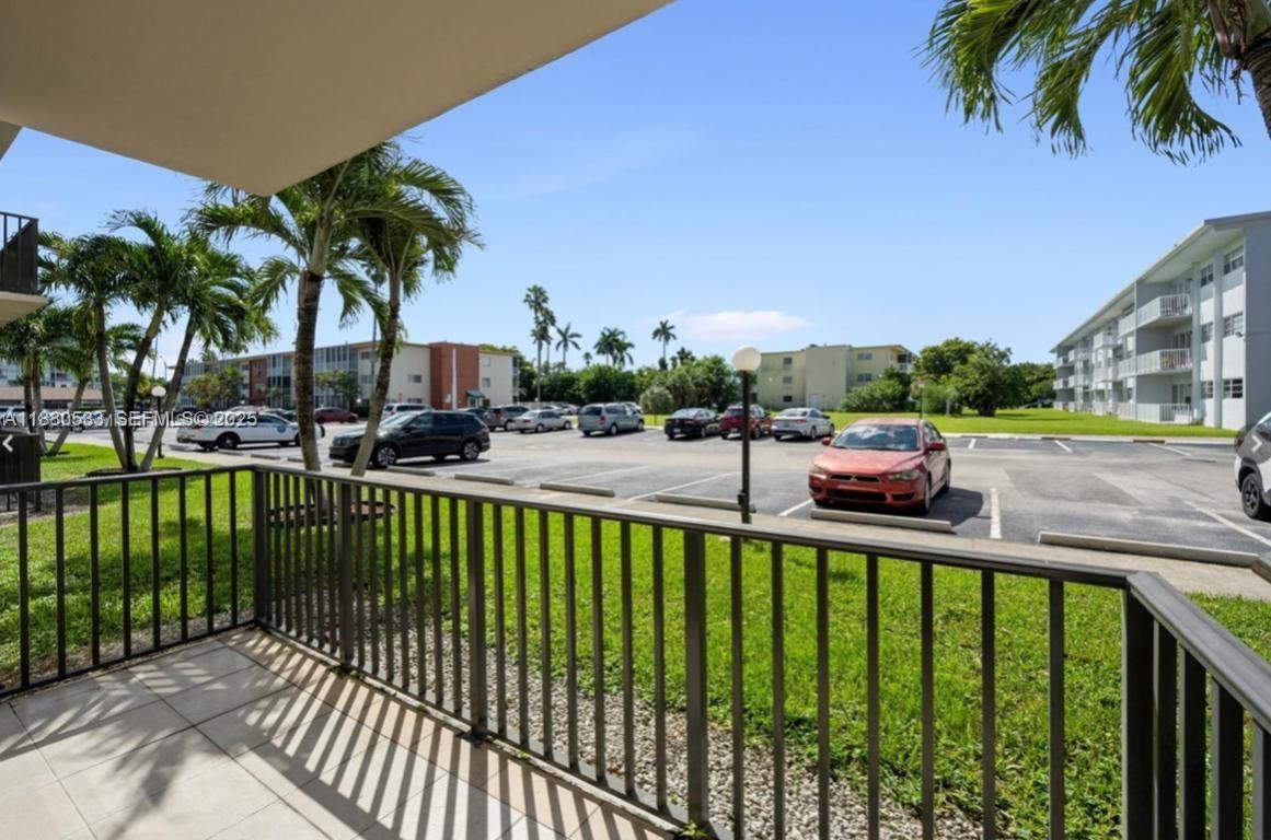 1400 Northeast 169th Street, Unit 115 Miami, FL 33162 - Photo 5 of 17 a view of a swimming pool with a patio