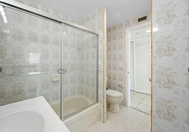 a bathroom with a shower and a toilet