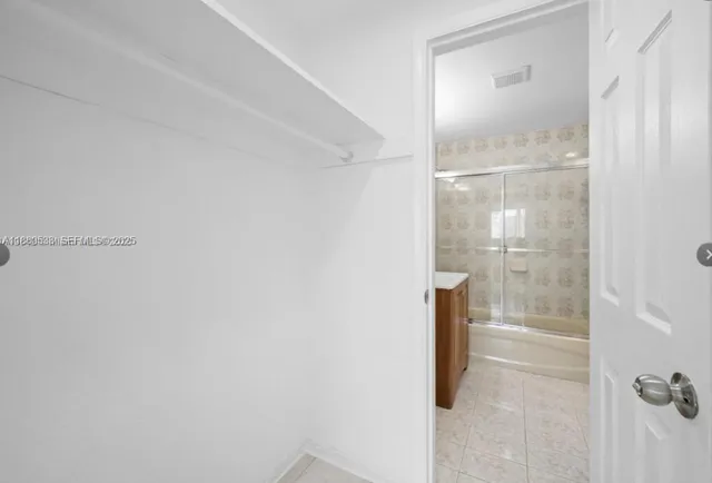 a bathroom with a glass shower door