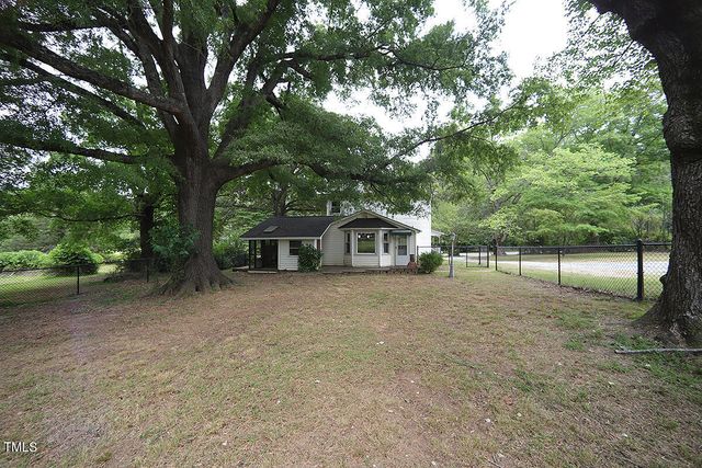 a house with trees in the background