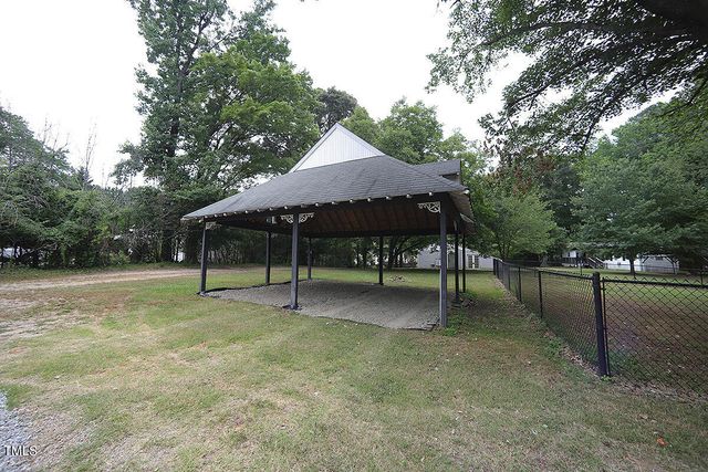 a view of house with backyard and slide