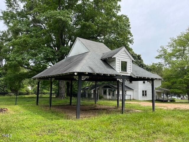 a backyard of a house with table and chairs
