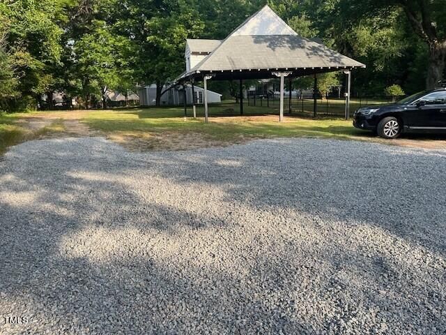 a view of a house with a yard and sitting area