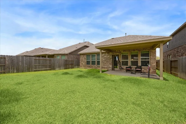 a view of a house with backyard porch and garden