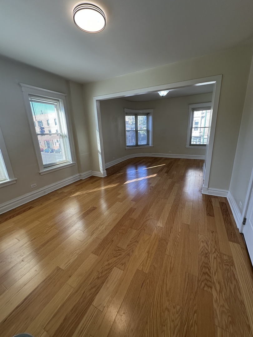 953 North California Avenue, Unit 2F Chicago, IL 60622 - Photo 11 of 16 a view of empty room with window and wooden floor