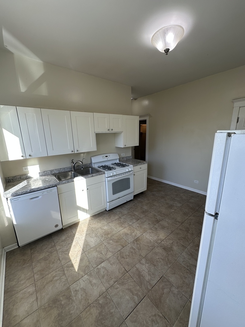 953 North California Avenue, Unit 2F Chicago, IL 60622 - Photo 16 of 16 a kitchen with stainless steel appliances a stove a sink and a refrigerator