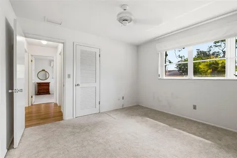 an empty room with windows and closet