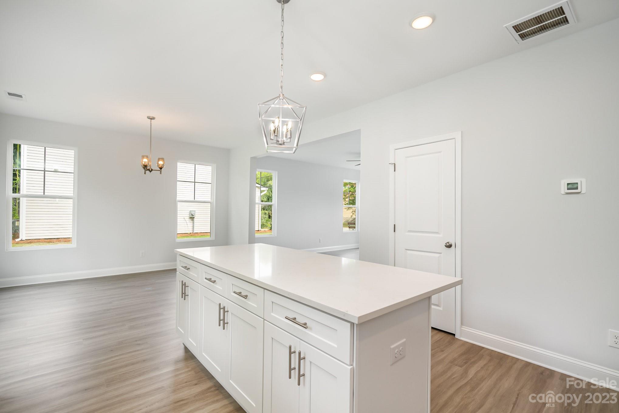 1016 Helms Road Charlotte, NC 28214 - Photo 14 of 39 an empty room with wooden floor and window