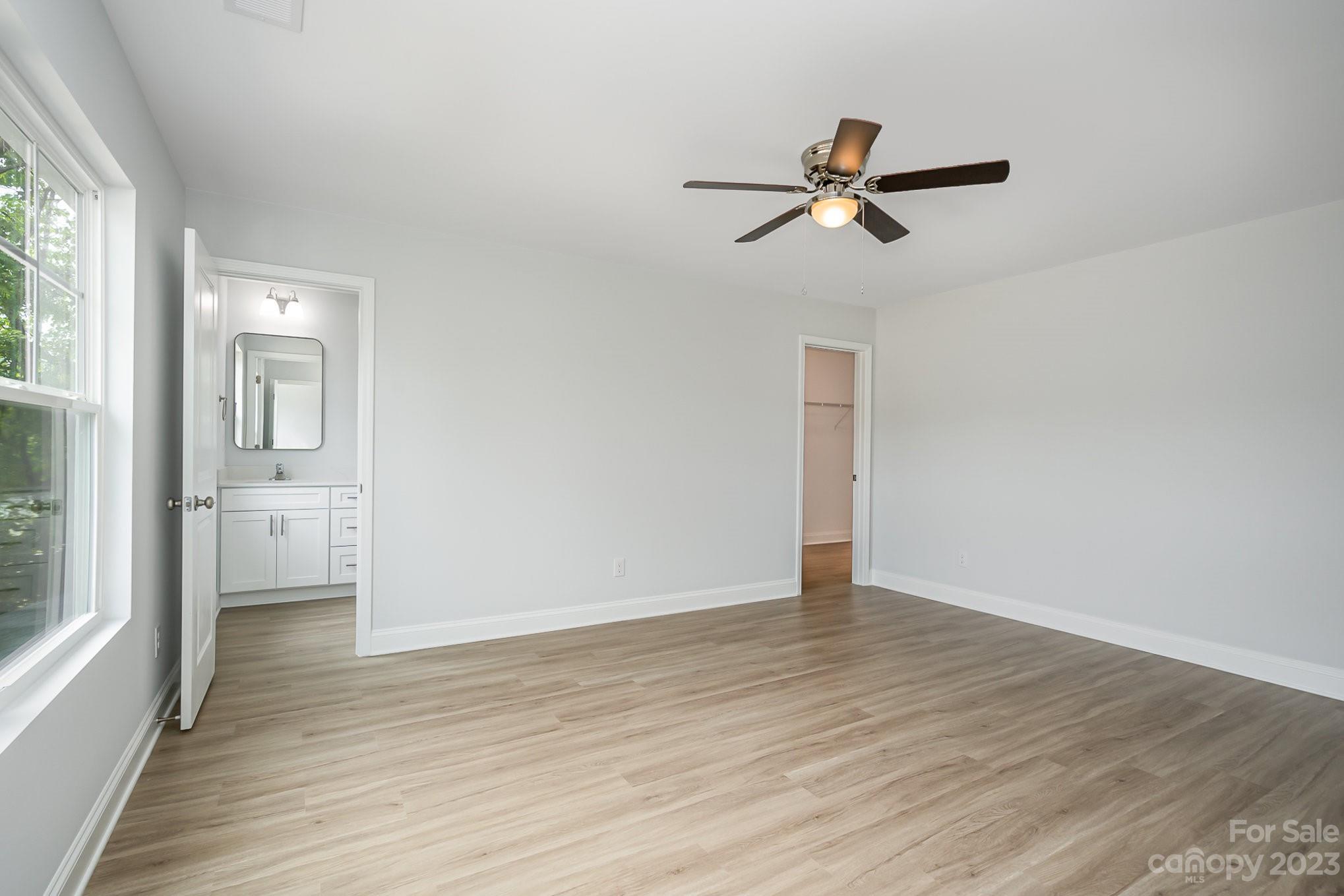 1016 Helms Road Charlotte, NC 28214 - Photo 20 of 39 a view of empty room with wooden floor and ceiling fan