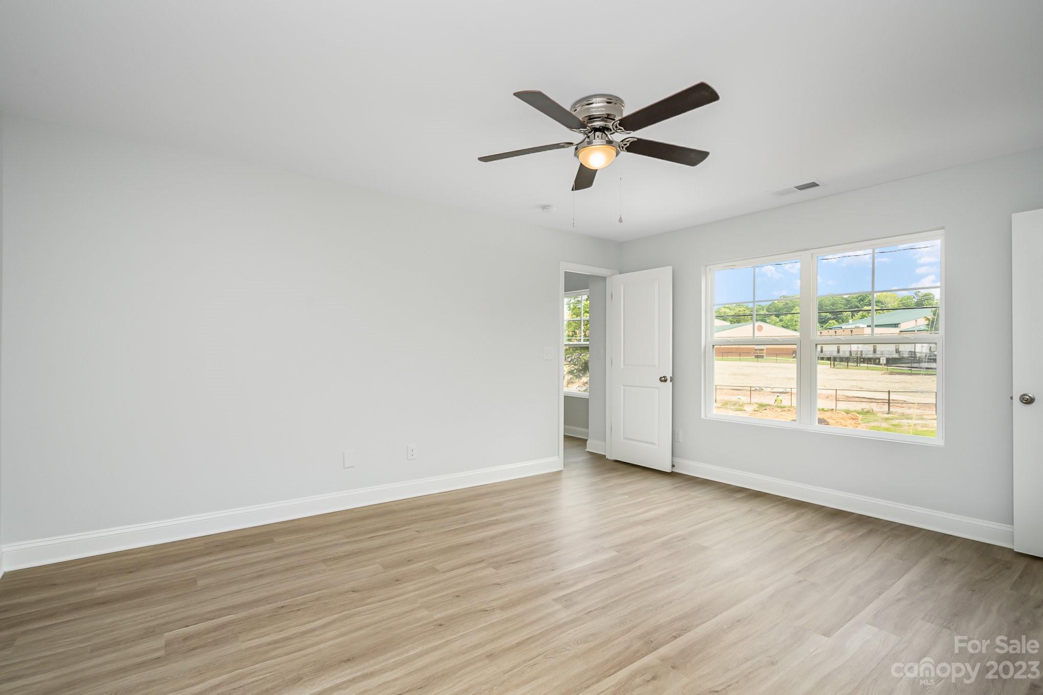 1016 Helms Road Charlotte, NC 28214 - Photo 22 of 39 a view of a big room with wooden floor and windows