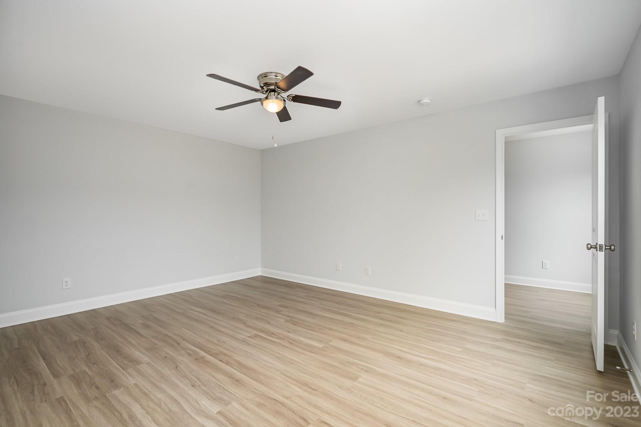 1016 Helms Road Charlotte, NC 28214 - Photo 23 of 39 a view of a big room with wooden floor closet and windows