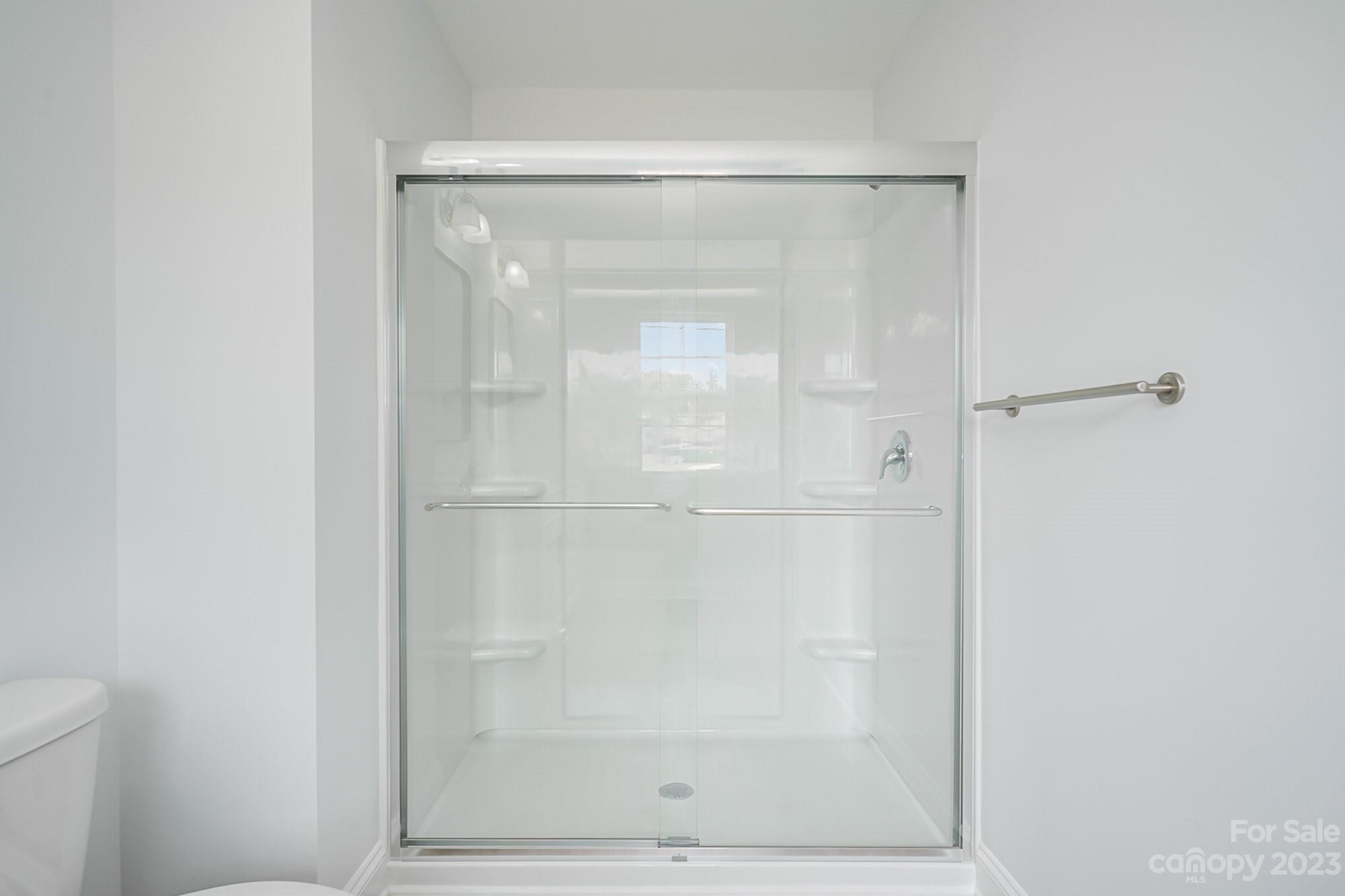 1016 Helms Road Charlotte, NC 28214 - Photo 25 of 39 a bathroom with a glass shower door
