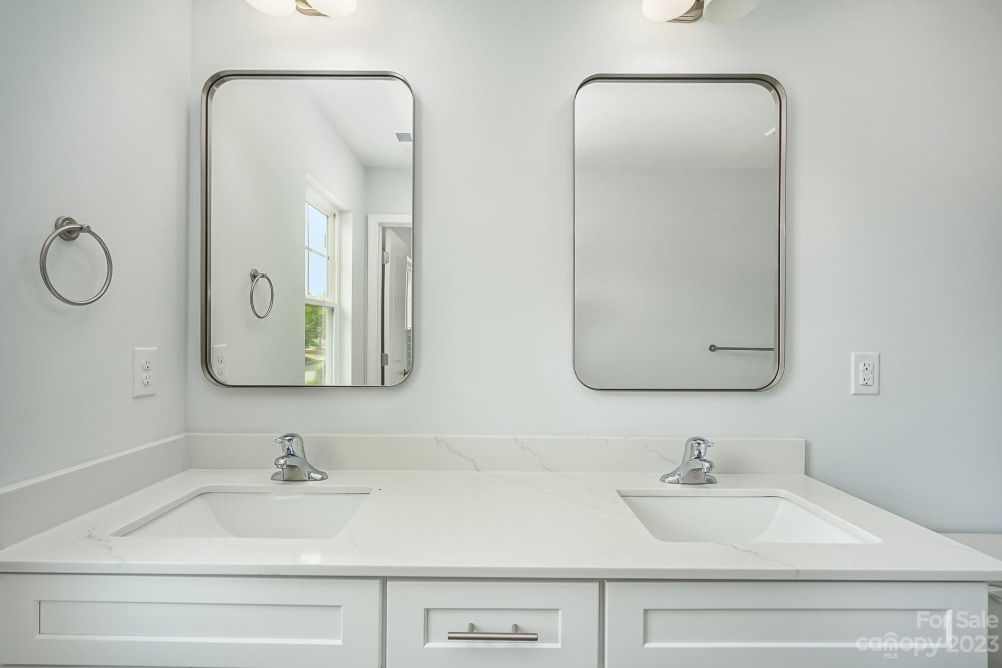 1016 Helms Road Charlotte, NC 28214 - Photo 26 of 39 a bathroom with double vanity sinks and a mirror