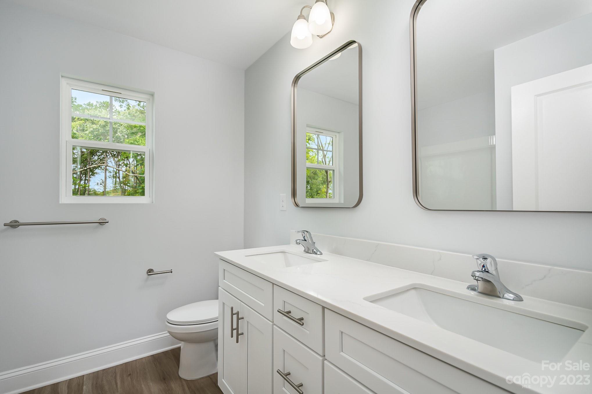 1016 Helms Road Charlotte, NC 28214 - Photo 28 of 39 a bathroom with a granite countertop toilet sink and mirror