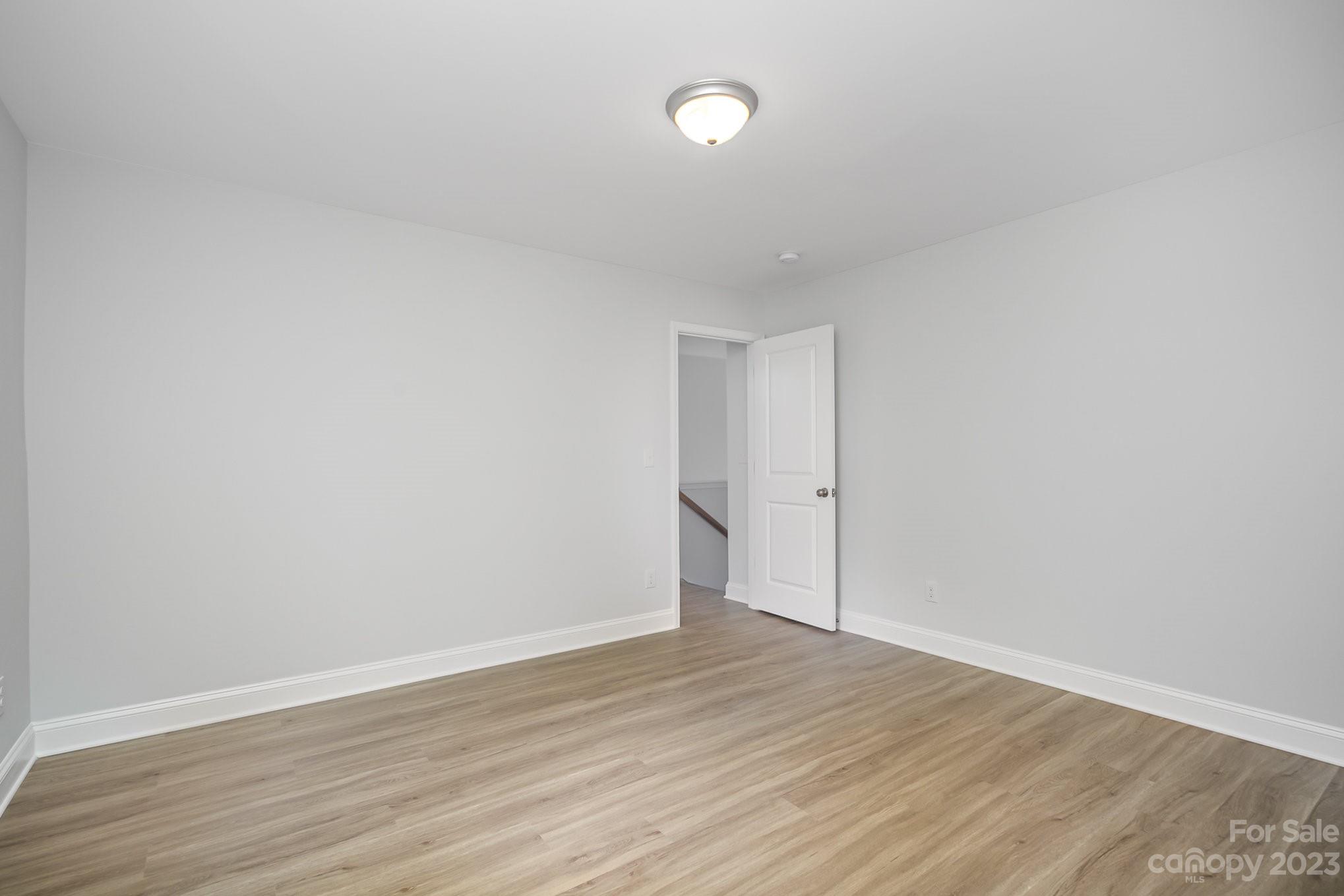 1016 Helms Road Charlotte, NC 28214 - Photo 30 of 39 a view of an empty room with wooden floor
