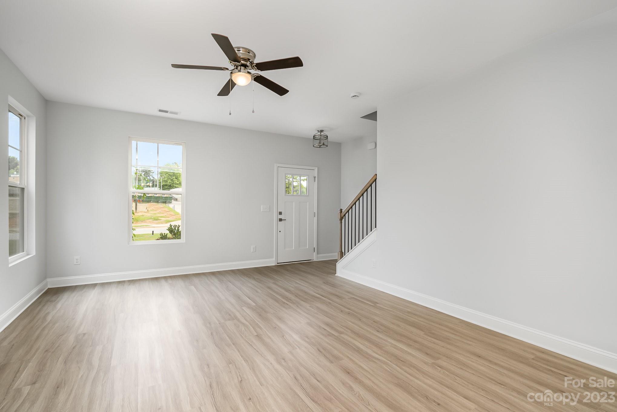1016 Helms Road Charlotte, NC 28214 - Photo 3 of 39 wooden floor in an empty room with a window
