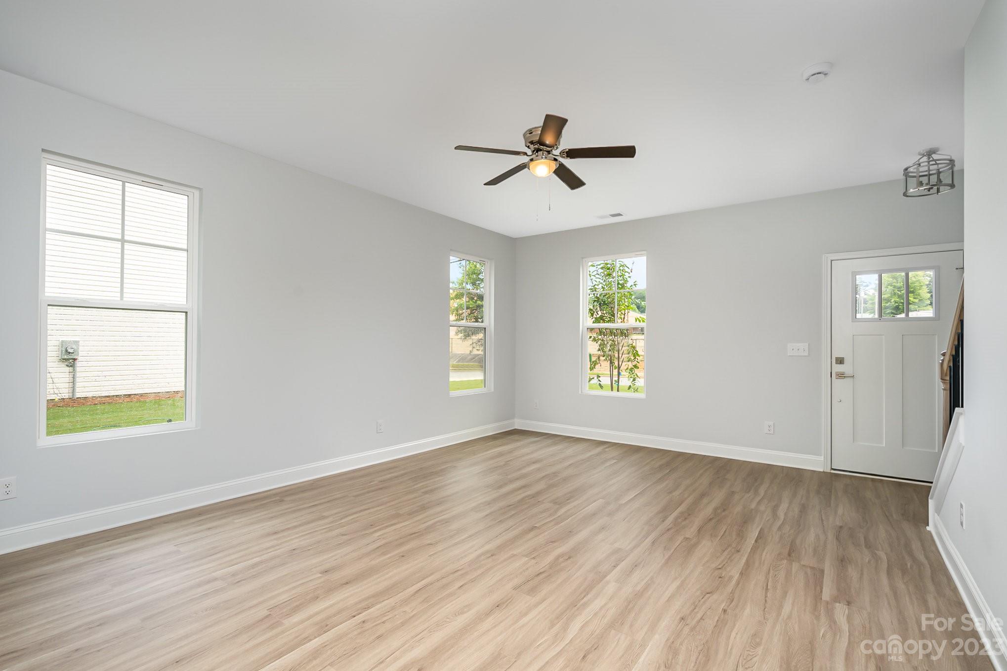 1016 Helms Road Charlotte, NC 28214 - Photo 4 of 39 a view of empty room with wooden floor and fan